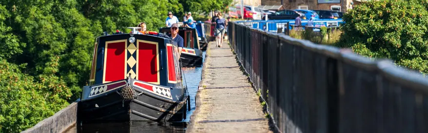 Canal boats travelling across the famous Pontcysyllte aqueduct